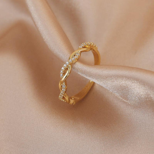 Adjustable ring with gold braided zirconia stones